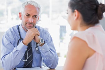 breast cancer doctor discussing diagnosis of breast cancer to patient