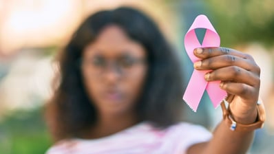 woman with breast cancer ribbon - more about triple negative breast cancer
